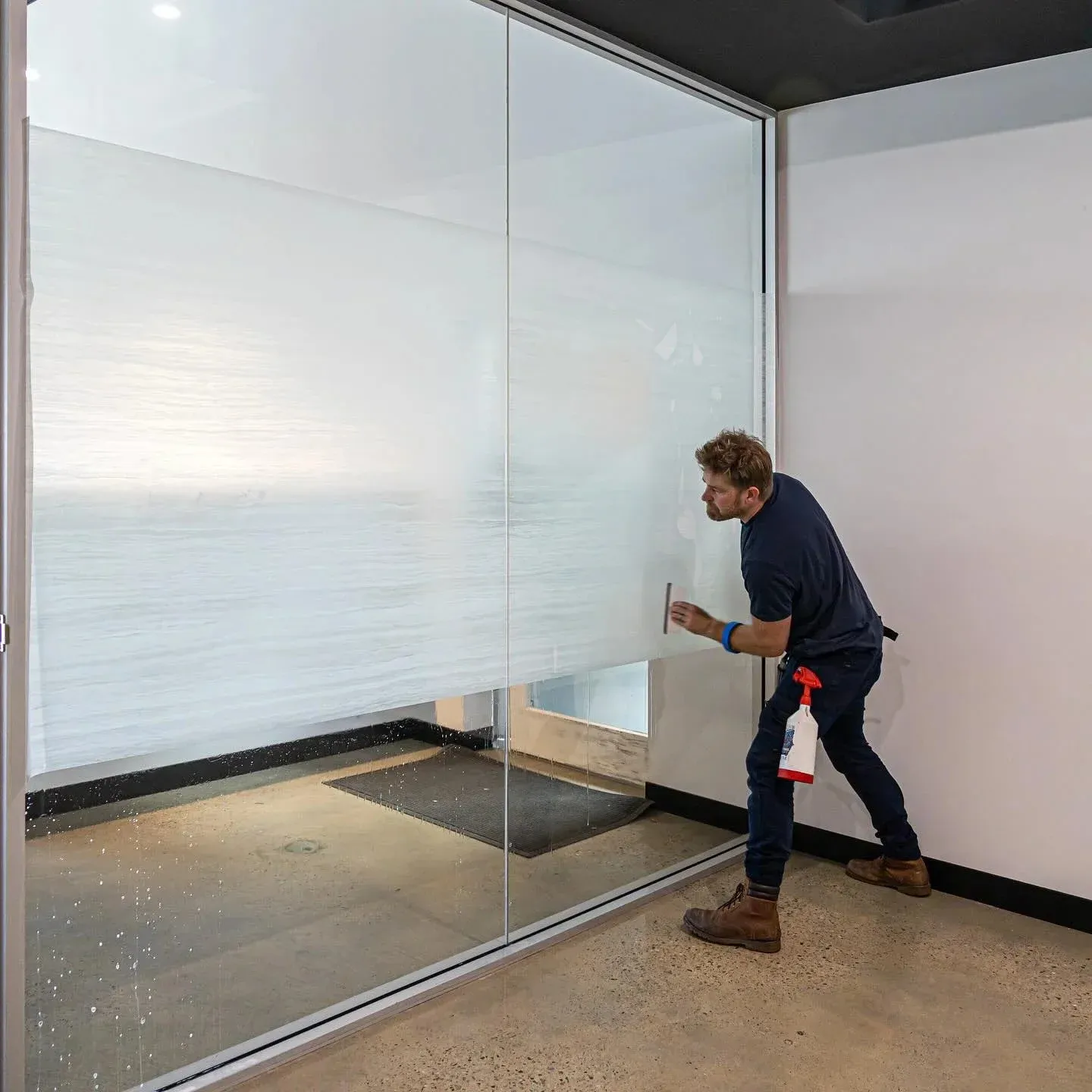 Footprint Creative installing frosted film on office glass