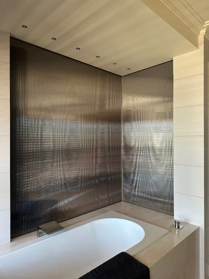 Reeded glass finish beside a residential bath
