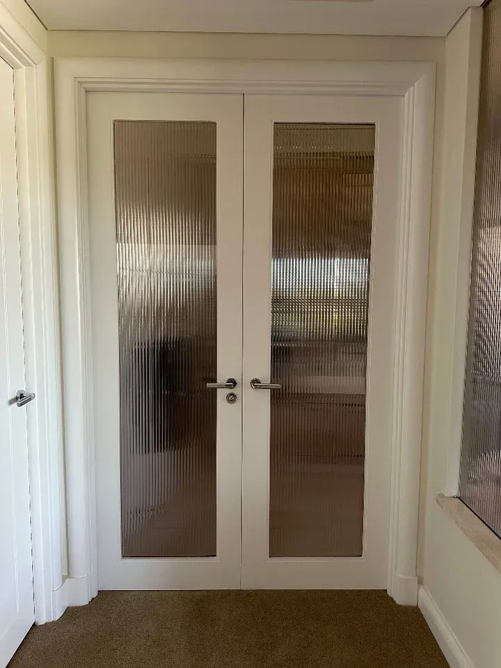 Reeded film fitted to white framed residential doors